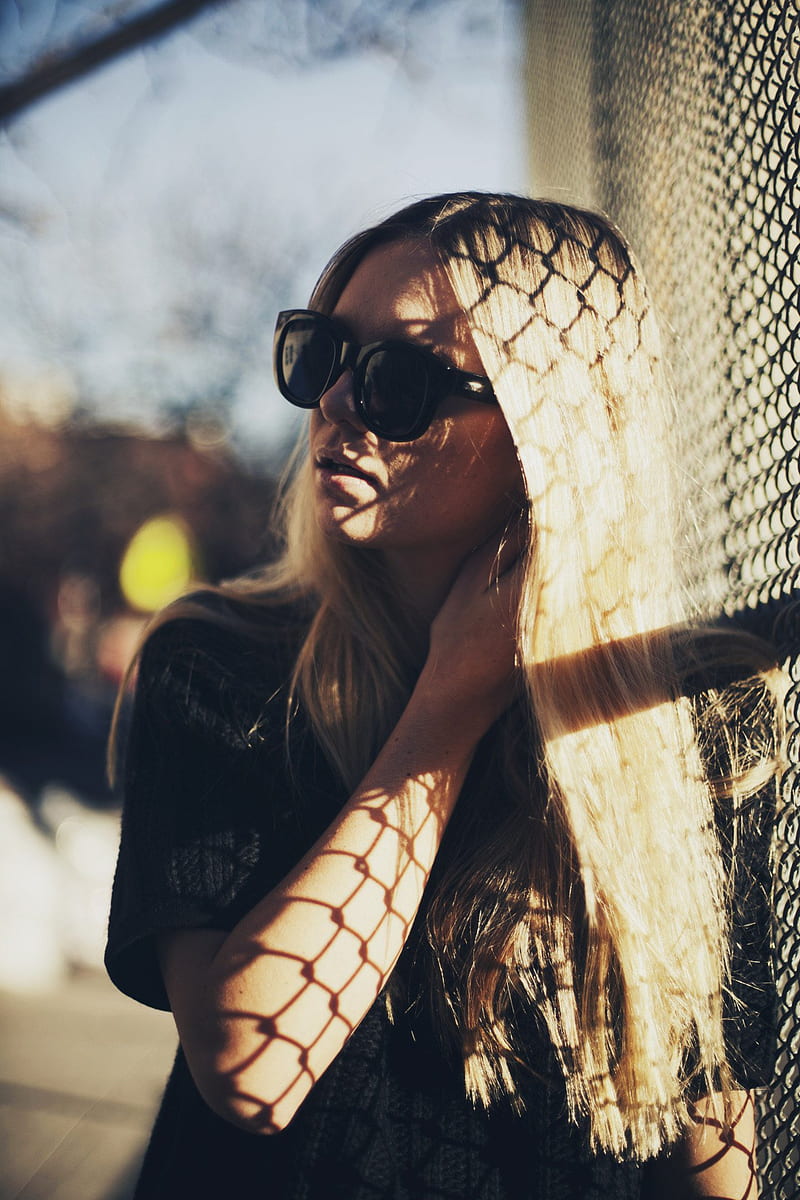 women, model, blonde, dyed hair, long hair, straight hair, glasses, women with glasses, sunglasses, women with shades, sunlight, natural light, vertical, fence, black clothing, looking away, women outdoors, bokeh, sky, HD phone wallpaper