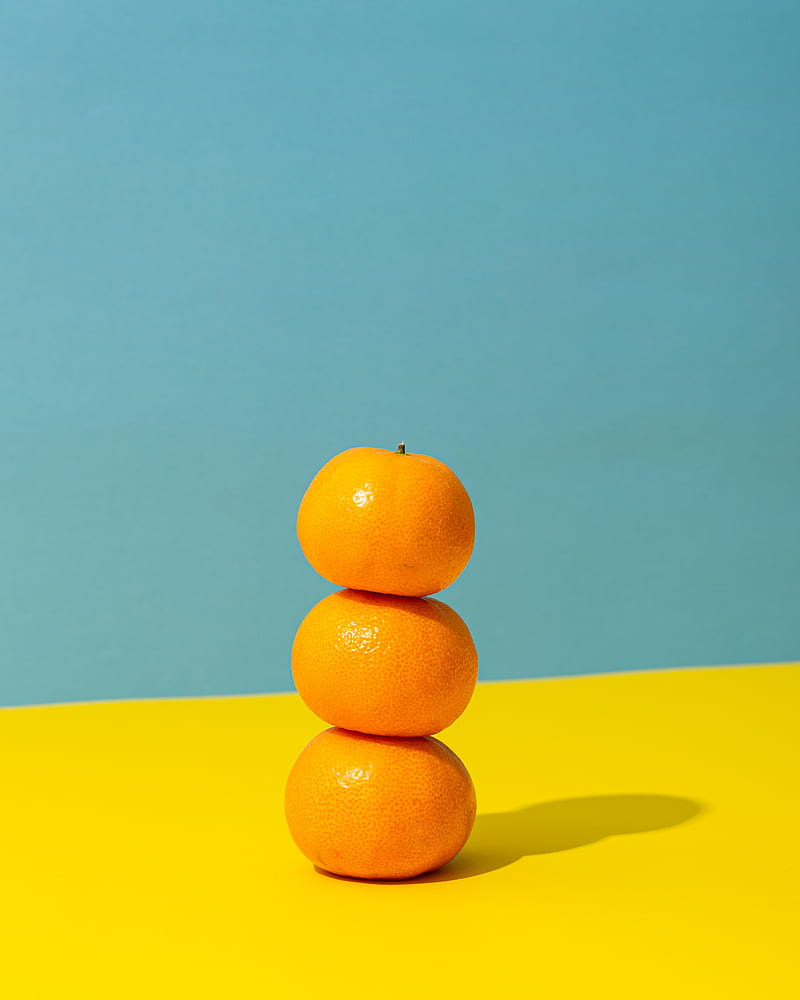 orange fruit on yellow surface, HD phone wallpaper