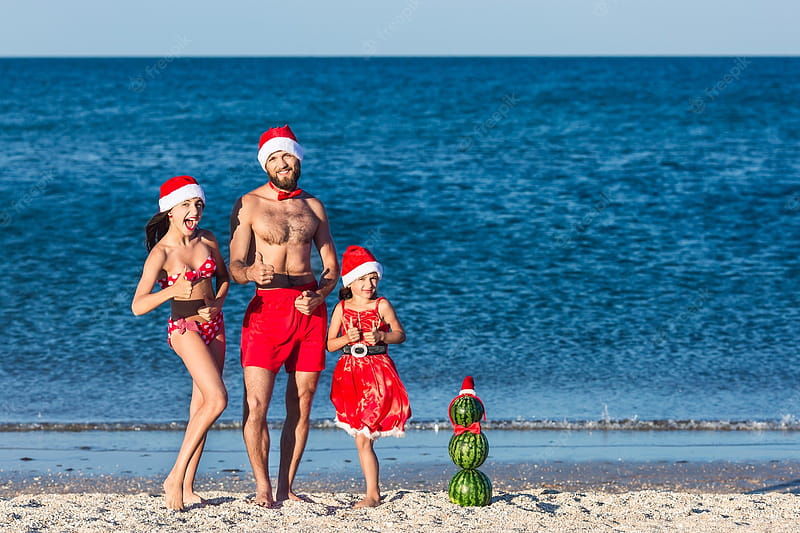 Premium . Young friendly family have fun celebrating summer christmas on the beach and showing like, HD wallpaper