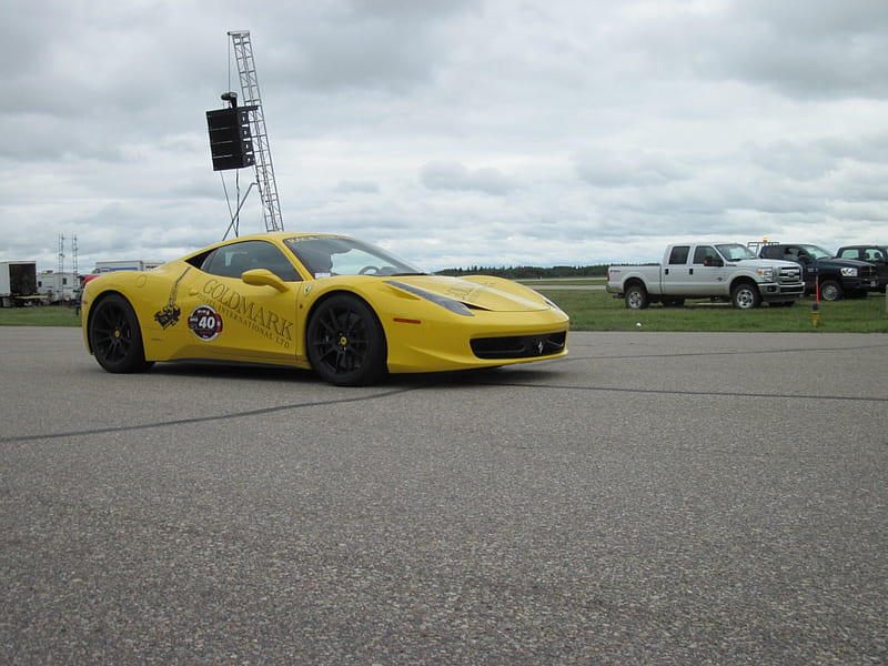 Ferrari on the race track, ferrari, car, black, yellow, tires, white, clouds, HD wallpaper