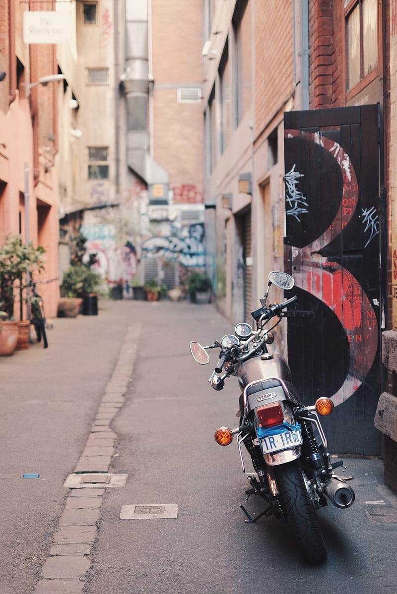 black motorcycle parked beside wall, HD phone wallpaper