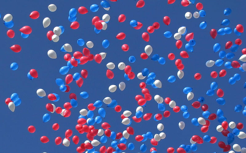 red white and blue balloons in the sky
