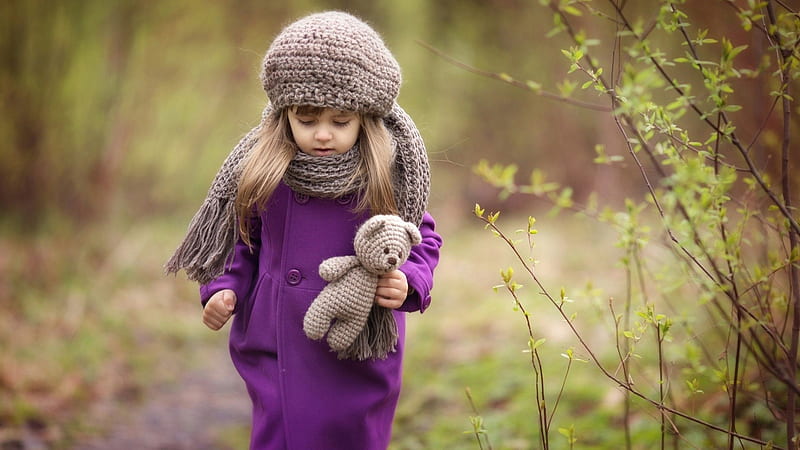 Cute Little Girl Is Wearing Purple Dress And Woolen Knitted Cap Having Woolen Toy In Blur Forest Background Cute, HD wallpaper