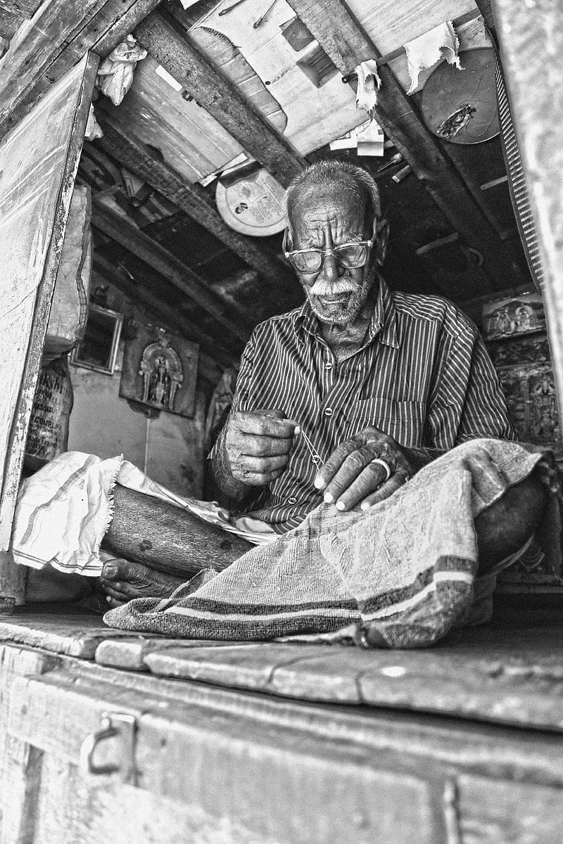 grayscale of man sewing textile while sitting on floor, HD phone wallpaper