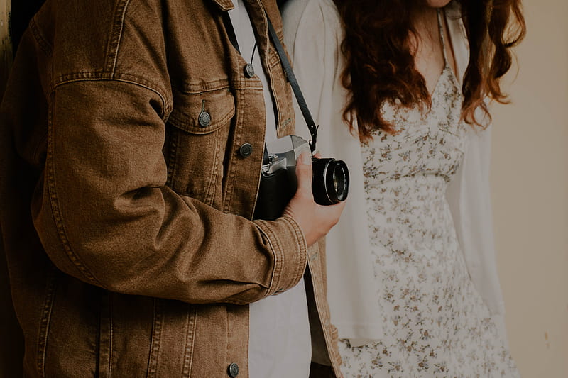 Woman in brown coat holding black camera, HD wallpaper | Peakpx