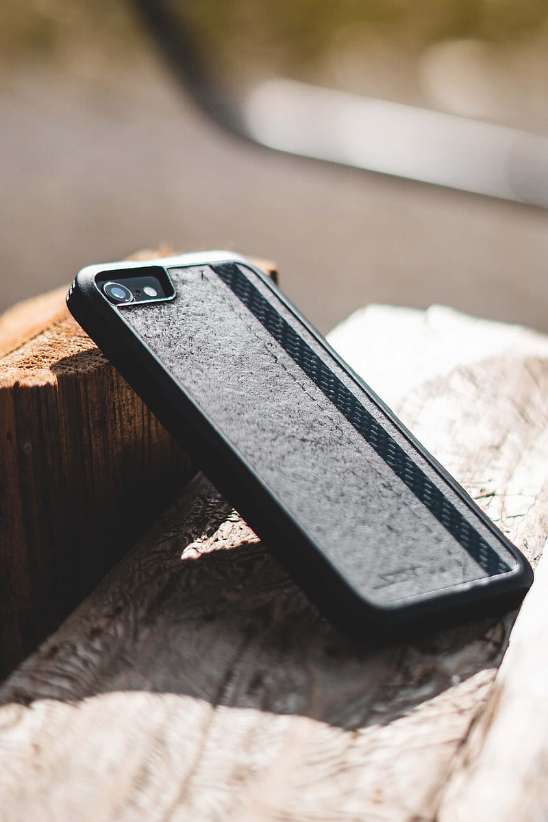black iphone case on brown wooden table, HD phone wallpaper