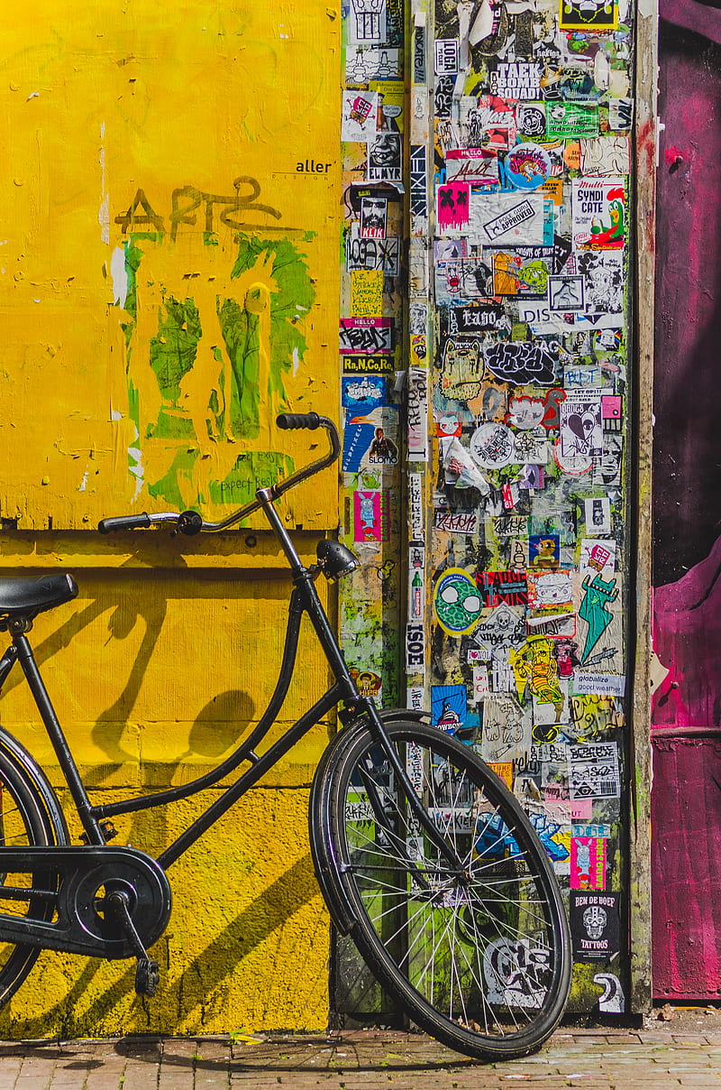 bike parked beside wall full of stickers, HD phone wallpaper
