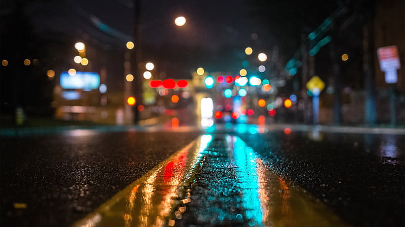 A downtown road covered in rain, glowing from nearby traffic lights, city, glow, town, rain, road, reflection, light, lights, HD wallpaper