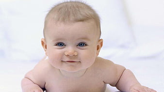 Cute Smiley Baby Is Lying Down On Floor Wearing Light Blue Dress In A ...