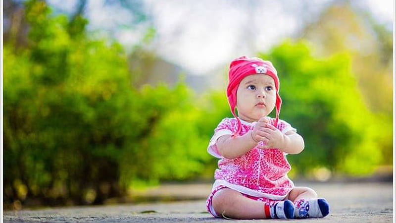 Cute Baby Child Is Wearing Pink White Dress And Cap Sitting In Green Blur Background Cute, HD wallpaper