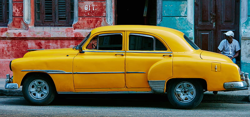 yellow sedan parked near red concrete building, HD wallpaper
