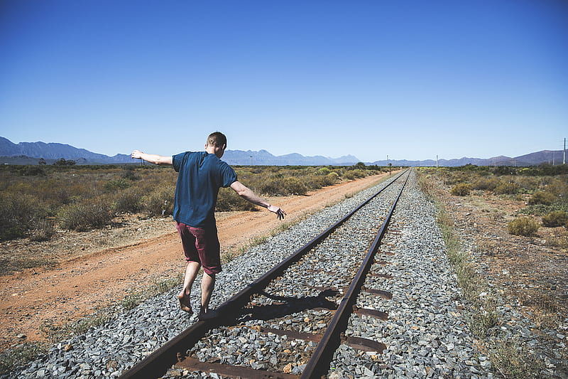 person walking on brown steel train rail outdoor during daytime, HD wallpaper