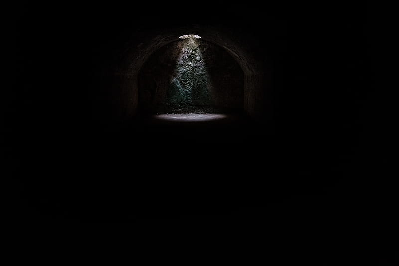 A spotlight coming from a hole in a dark underground cave in Minorca, HD wallpaper
