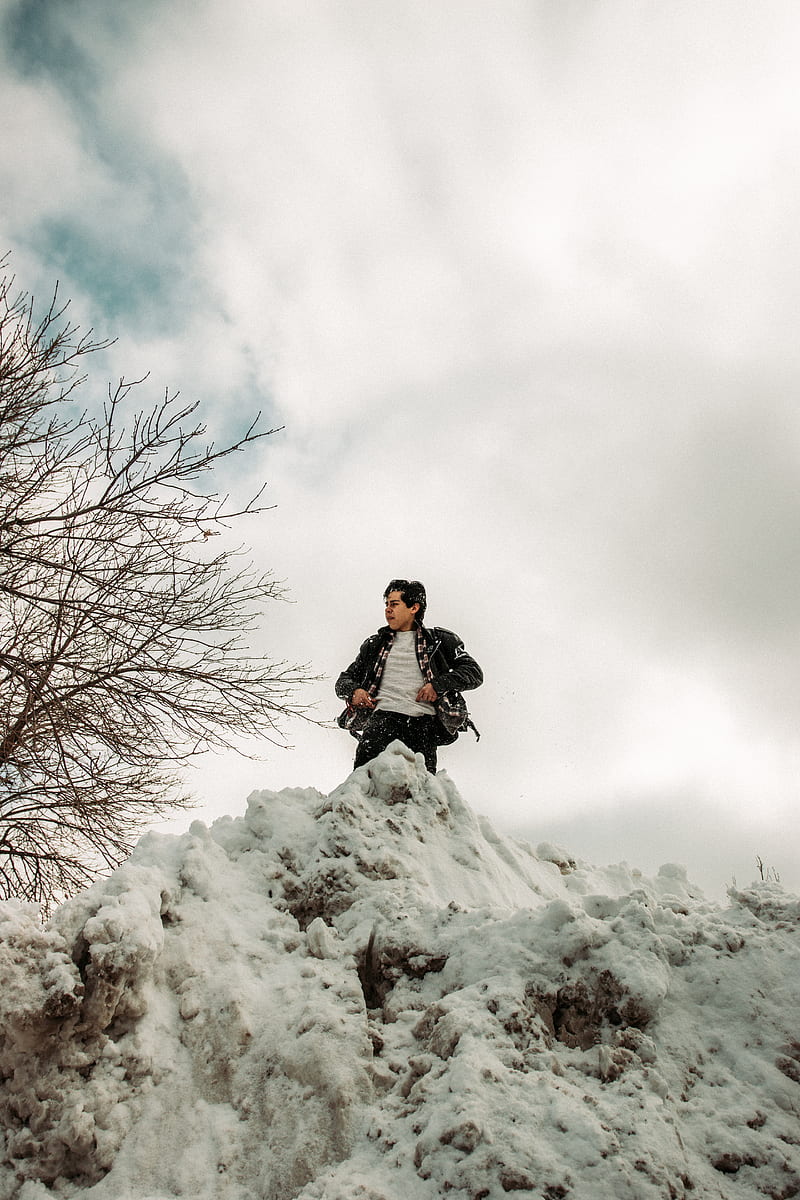 man in black jacket sitting on snow covered ground during daytime, HD phone wallpaper