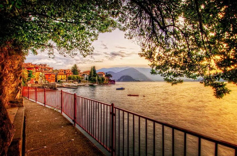 Lake Como in sunset, quiet, waterfront, buildings, town, como, sunset, trees, lake, melancholy, mountains, color, nature, street, HD wallpaper