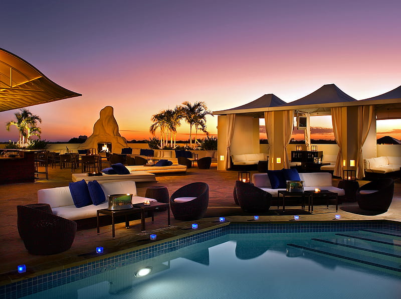 Pool at dusk, cabanas, dusk, umbrella, bonito, sunset, lights, fireplace, stones, chairs, hight definition, evening, reflection, tents, amazing, lanterns, tables, sofas, votives, pool, tv, candles, fire, wicker chairs, pillows, HD wallpaper