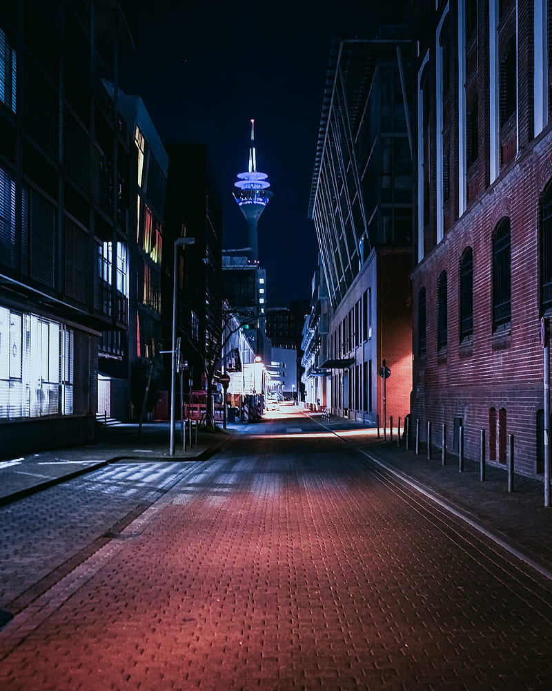 red brick road between buildings during night time, HD phone wallpaper