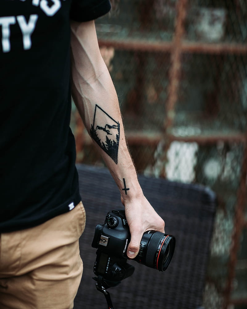 Panama, Bocas del Toro, Man with camera and camera tattoo on the arm stock  photo