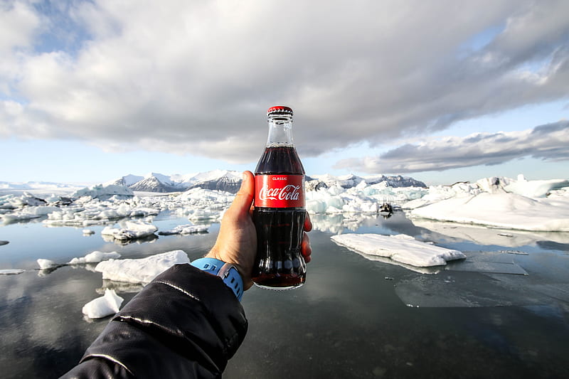 person showing of bottle of coke in front of icebergs, HD wallpaper