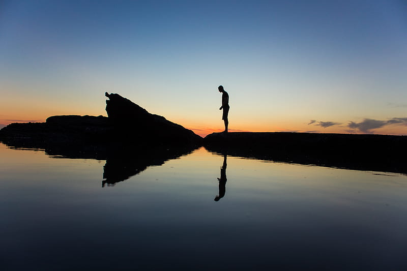 silhouette of man standing on land near body of water with reflection, HD wallpaper