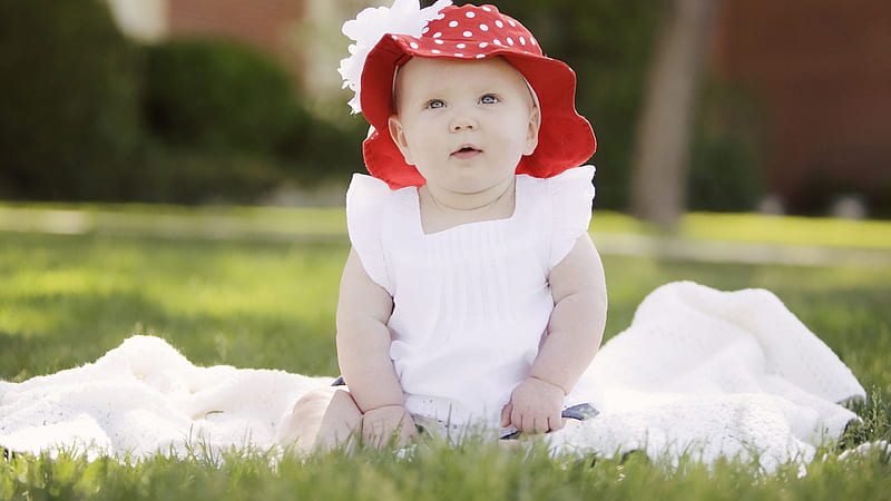 Cute Baby Is Sitting On Green Grass Wearing White Dress Red Cap In Blur Background Cute, HD wallpaper