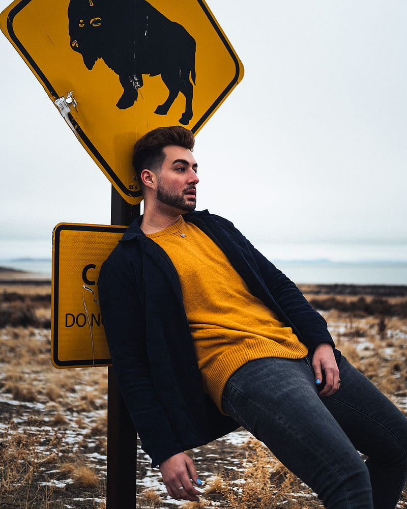 man in yellow and black jacket and blue denim jeans sitting on yellow surfboard during daytime, HD phone wallpaper