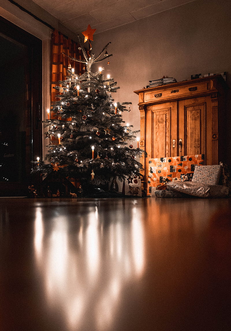 Christmas tree with turned on mini string lights near cabinet, HD phone wallpaper