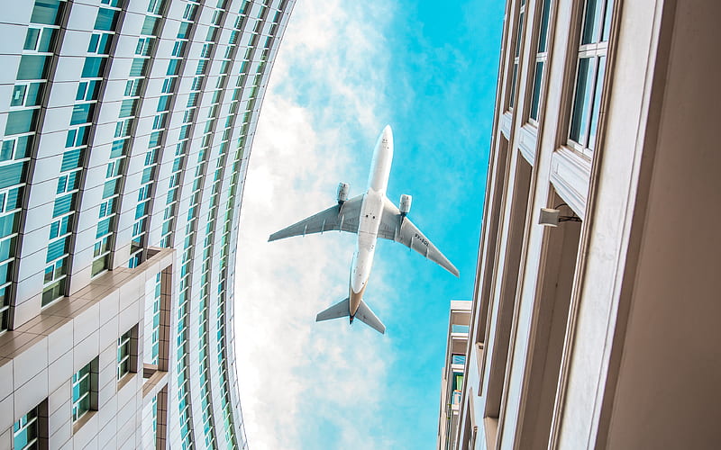 passenger plane over buildings, plane over the city, airplane bottom view, blue sky, building, air travel concept, HD wallpaper