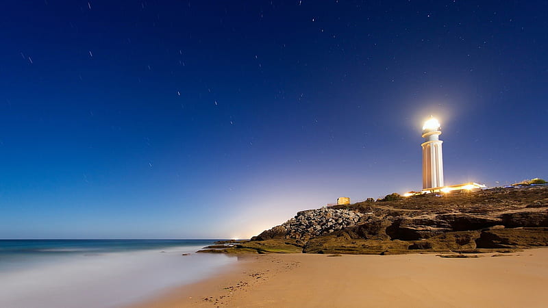 bright lighthouse at night, rocks, stars, coast, lighthouse, sea, light, HD wallpaper