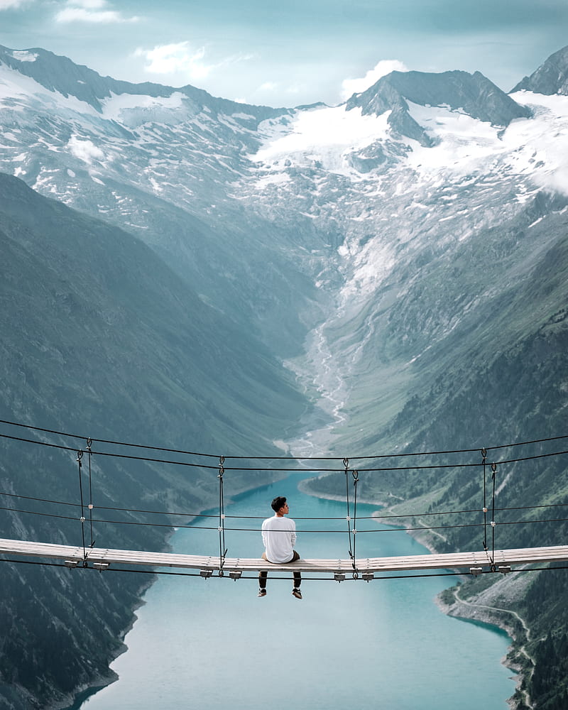man wearing white shirt siting on bridge overlooking at mountain, HD phone wallpaper