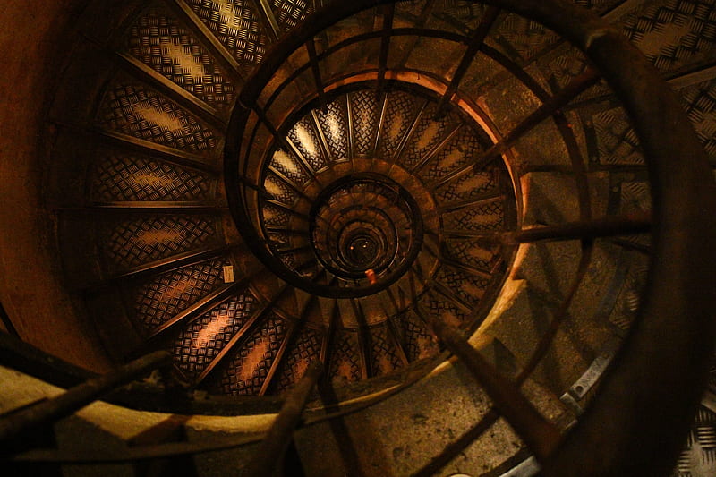 A worn spiral staircase with dark wood and faded designs, HD wallpaper
