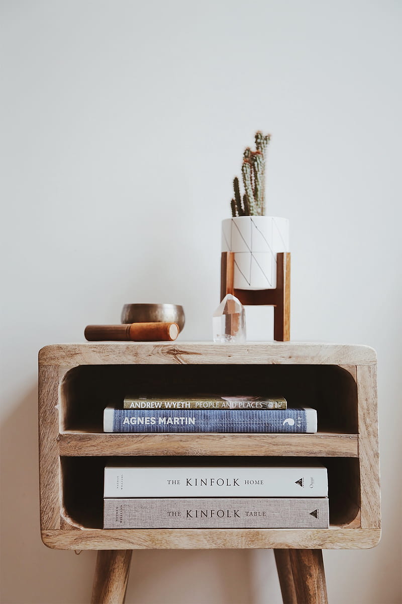 books in brown wooden side table beside white wall, HD phone wallpaper