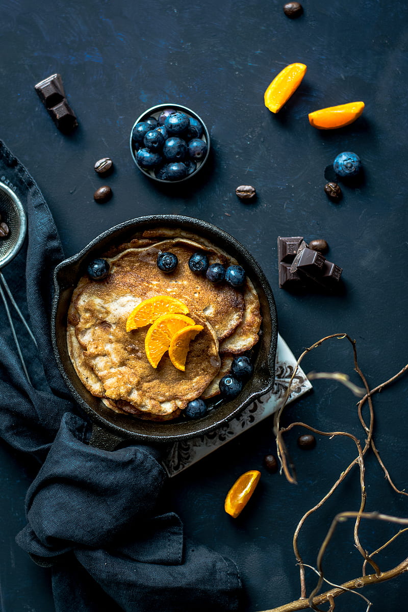 pancake with orange and blueberries beside scattered chocolate and coffee beans, HD phone wallpaper