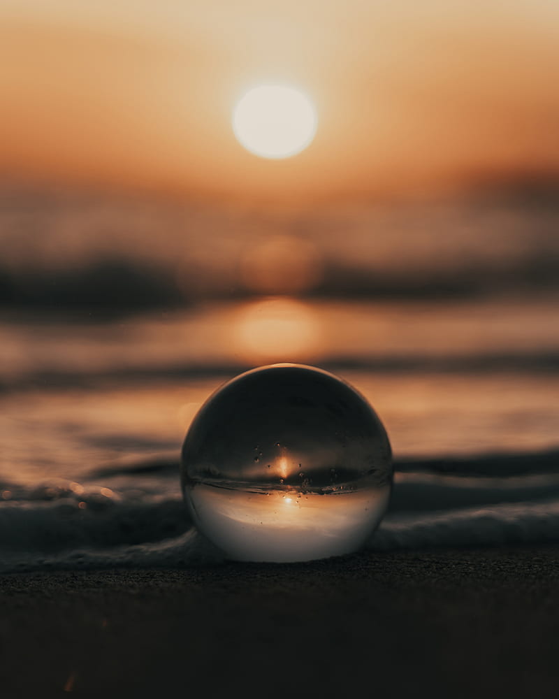 clear glass ball on brown sand during sunset, HD phone wallpaper