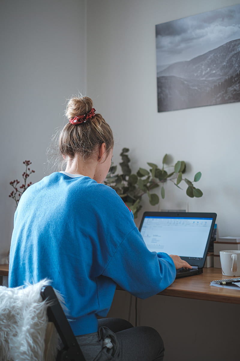 woman in blue sweater sitting in front of laptop computer, HD phone wallpaper