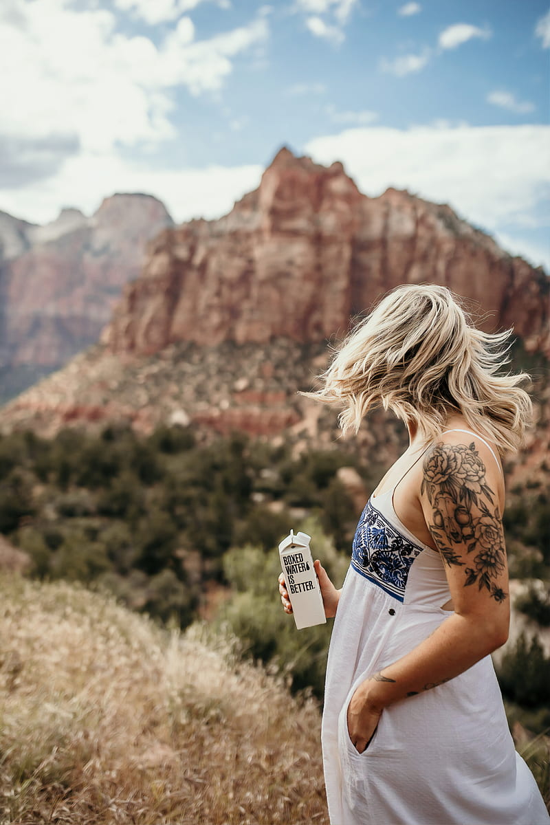 woman holding 500 mL of Boxed Water at the mountain, HD phone wallpaper