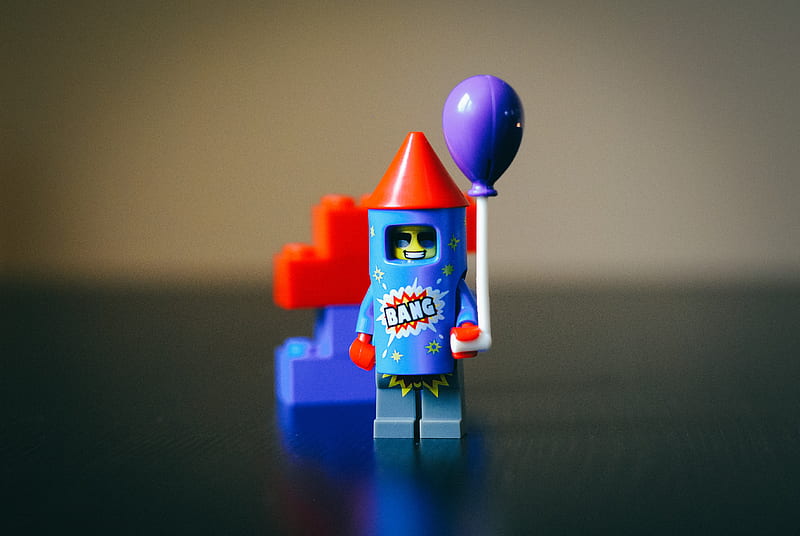 teal, red, and purple LEGO plastic firecracker toy in focus graphy, HD wallpaper