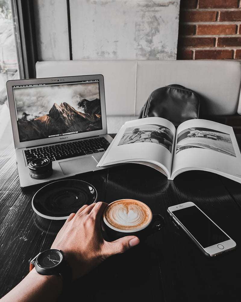 man holding cup of latte on table with MacBook Air and book, HD phone wallpaper
