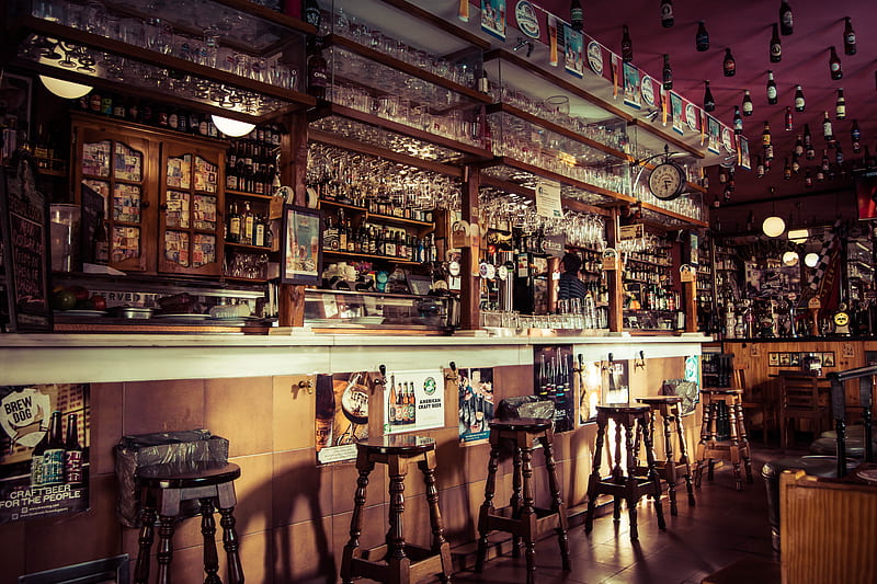 The interior of a bar with stools, glass cups and empty bottles attached to the roof in Madrid, HD wallpaper