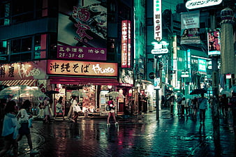 People walking on street near brown concrete building during night time ...