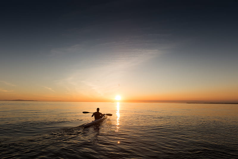man riding kayak on water taken at sunset, HD wallpaper
