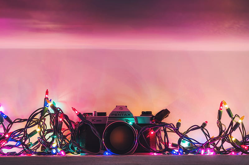 black and silver Pentax range finder camera surrounded by string lights, HD wallpaper