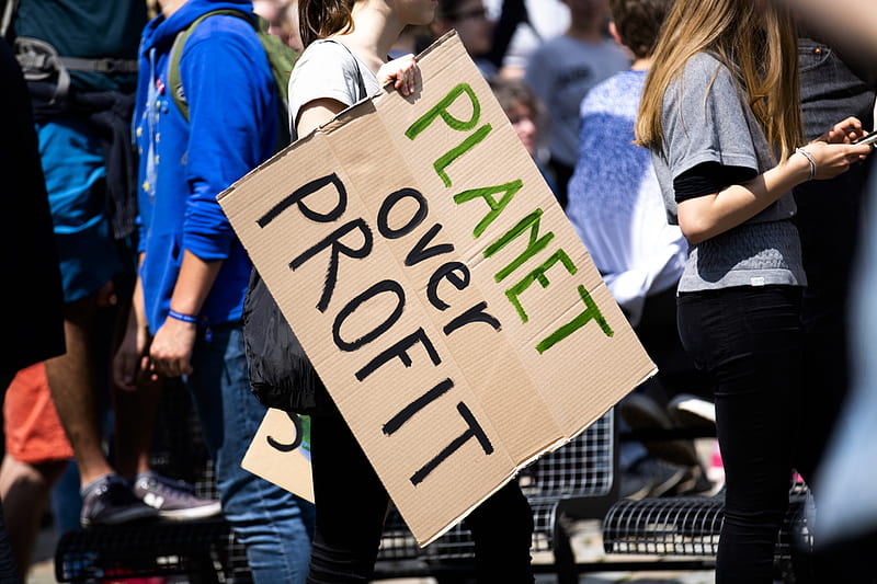 woman holding Planet over Profit placard, HD wallpaper
