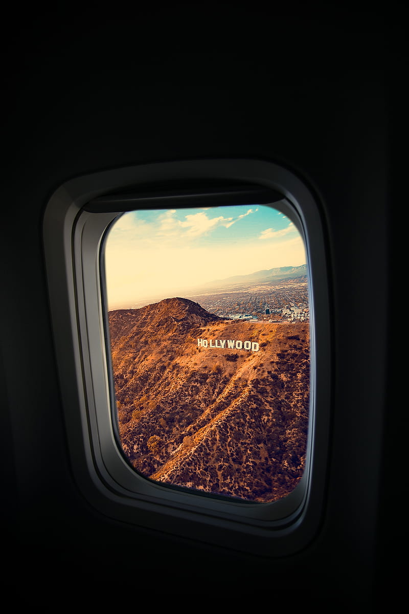 person inside plane looking hollywood standing letter at daytime, HD phone wallpaper