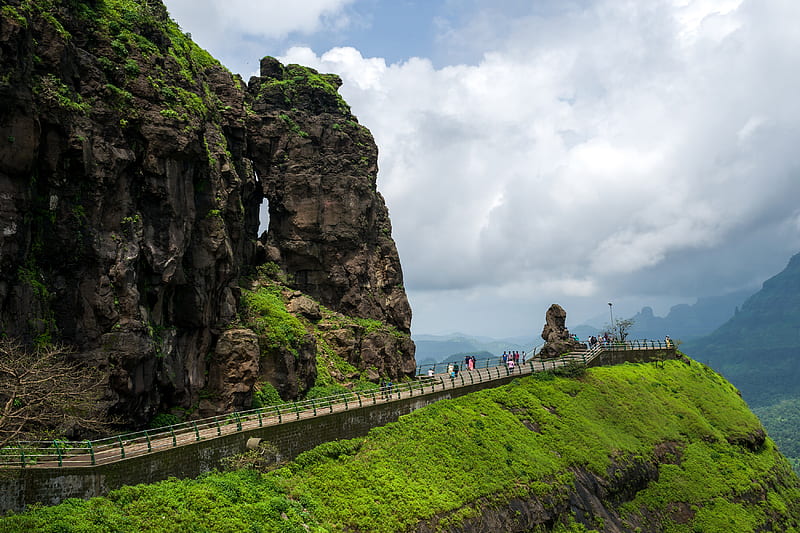 people walking on gray concrete bridge near brown rock formation during daytime, HD wallpaper