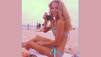 Ellen Hollman relaxing on the beach beach scene drinking wine