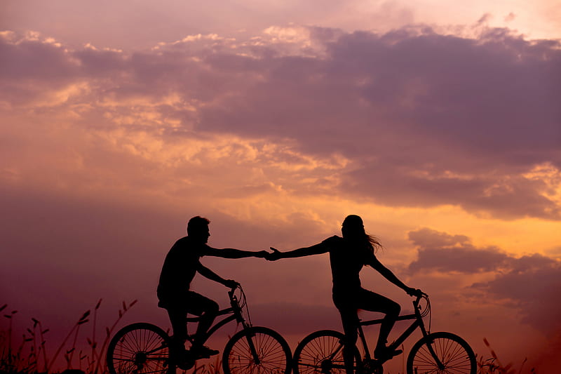 woman on bike reaching for man's hand behind her also on bike, HD wallpaper