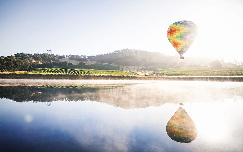 hot air balloon floating in mid air above body of water, HD wallpaper