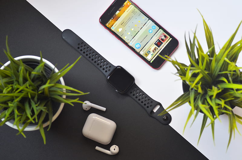 Apple Watch between iPhone and AirPods on table, HD wallpaper