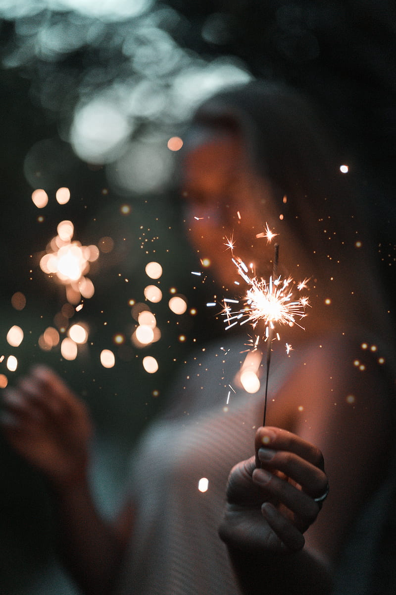 woman holding fire cracker in selective focus graphy, HD phone wallpaper
